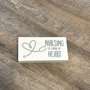 “Nursing is a work of heart” decorative sign.